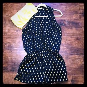 Navy romper with yellow accents.
